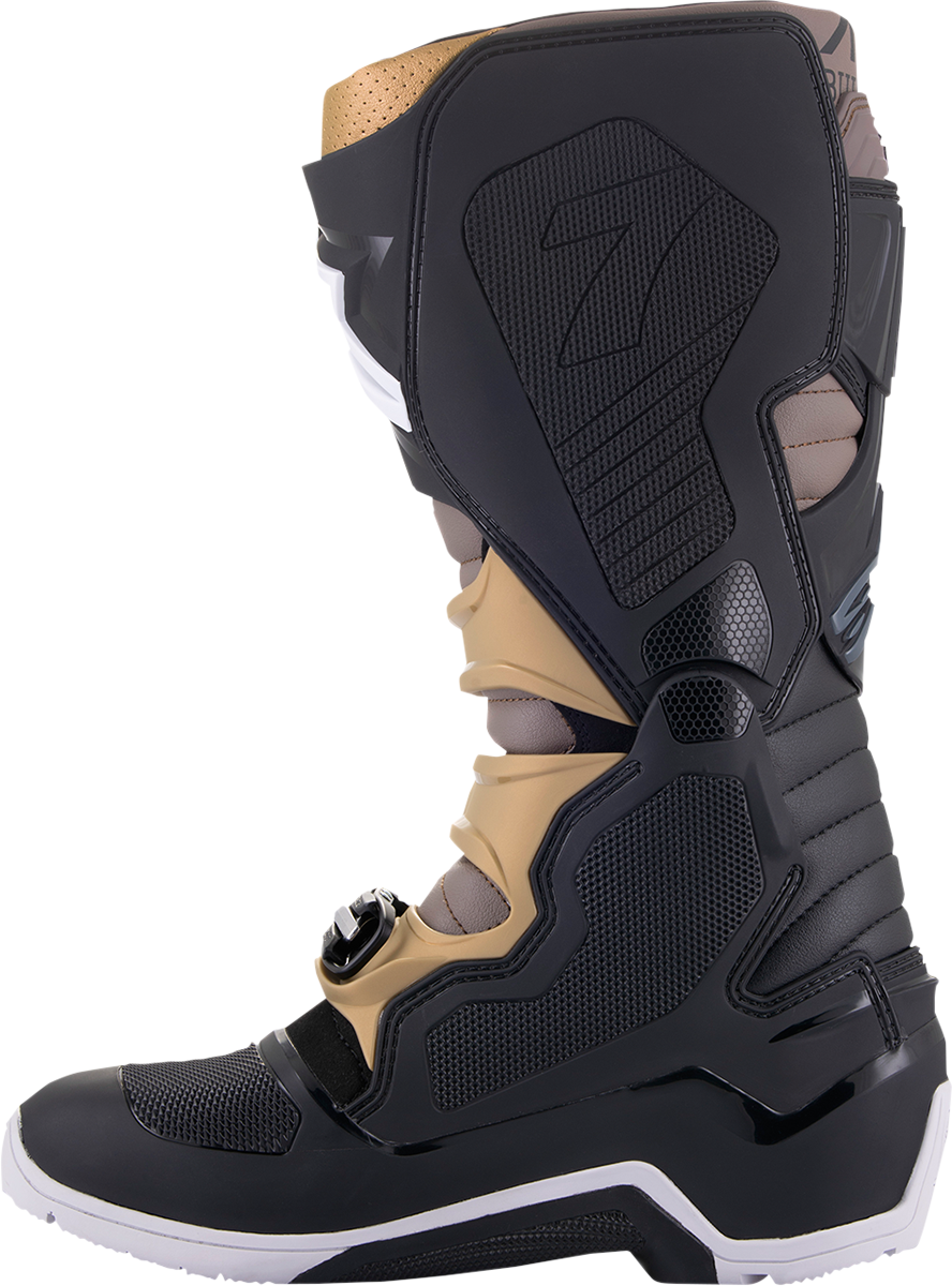 Alpinestars Tech 7 Enduro Drystar® motorcycle boots in black, gray, and gold with reinforced protection and sturdy design.