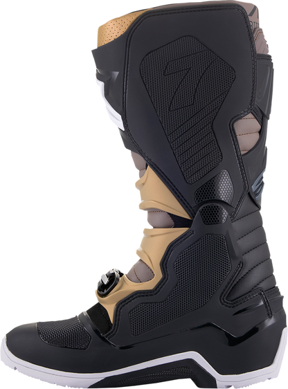 Alpinestars Tech 7 Enduro Drystar boots in black, gray, and gold with sturdy design, ankle protection, and rugged outsoles.