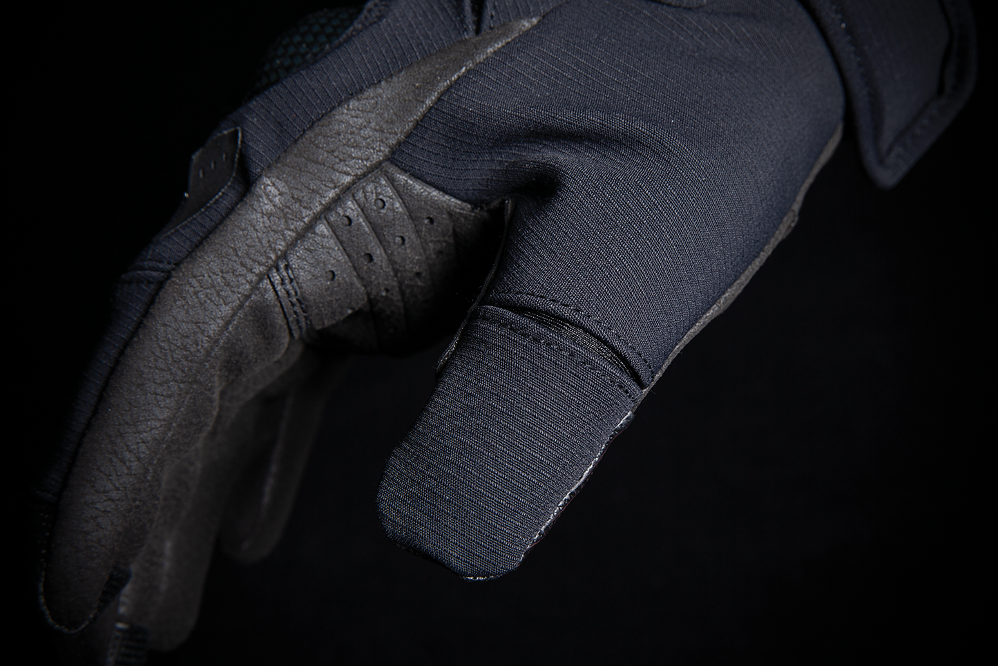 Black ICON Stormhawk™ gloves in 3XL size with textured fingertips and adjustable wrist strap, designed for durability and comfort.