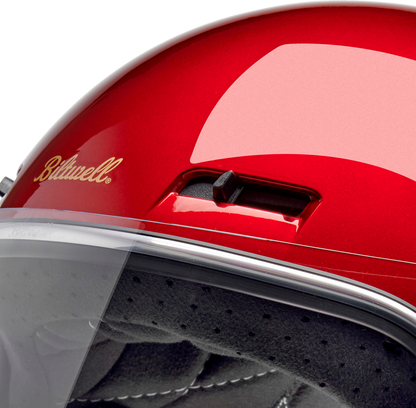 Metallic cherry red BILTWELL Gringo SV motorcycle helmet with a sleek design, medium size, and aerodynamic shape.