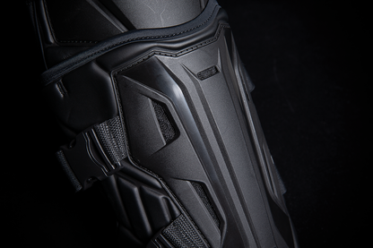 Black ICON Field Armor 3™ knee armor by Bill's Exhausts, showing padded protective gear with adjustable straps in a natural stance.