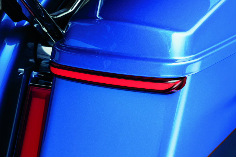 Kuryakyn Tracer Saddlebag Lights with red lens installed on Harley Davidson Touring motorcycle for enhanced visibility.