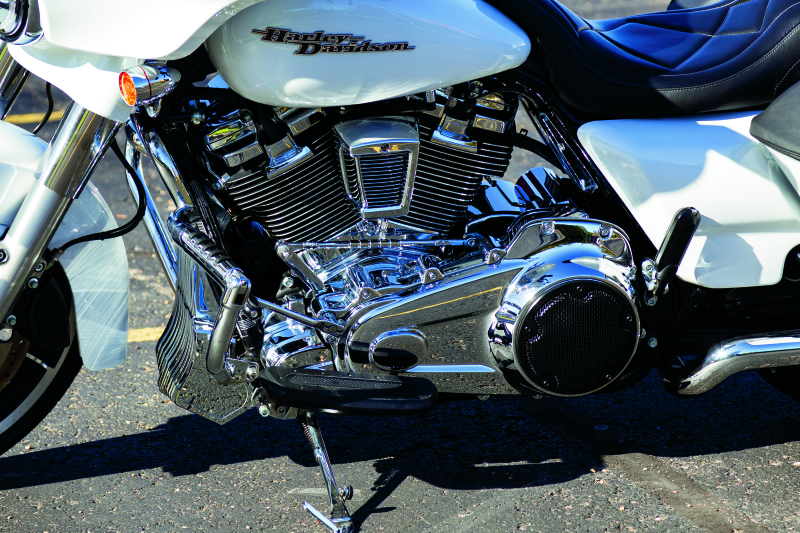 Chrome Kuryakyn Oil Cooler Cover for Harley Davidson Touring models, featuring a sleek metallic finish and detailed branding.