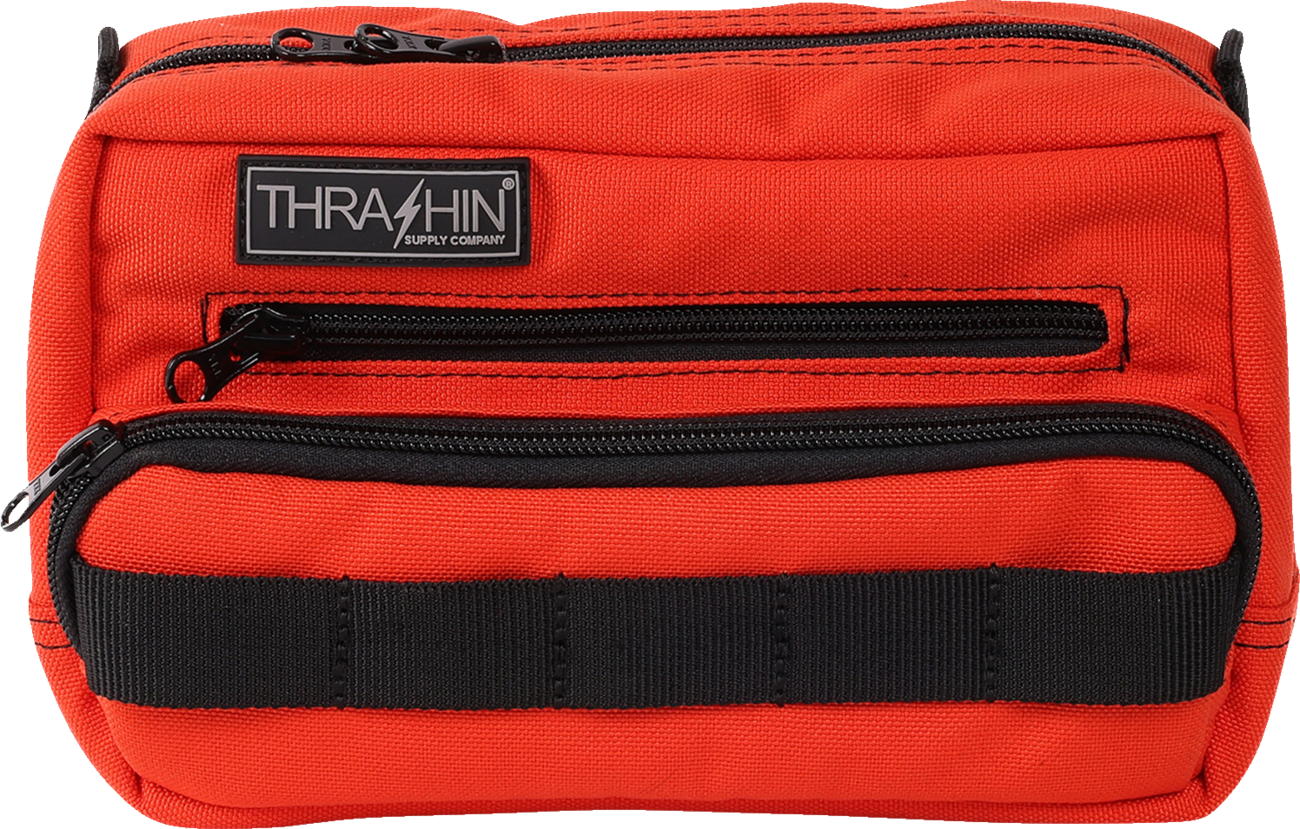 Orange THRASHIN SUPPLY CO. Handlebar Bag Plus mounted on a bicycle handlebar, showing its compact, durable design.