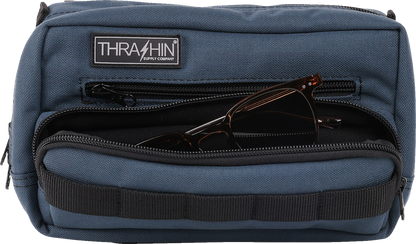 Blue THRASHIN SUPPLY CO. Handlebar Bag Plus mounted on a bicycle handlebar, showcasing its compact design and secure attachment.
