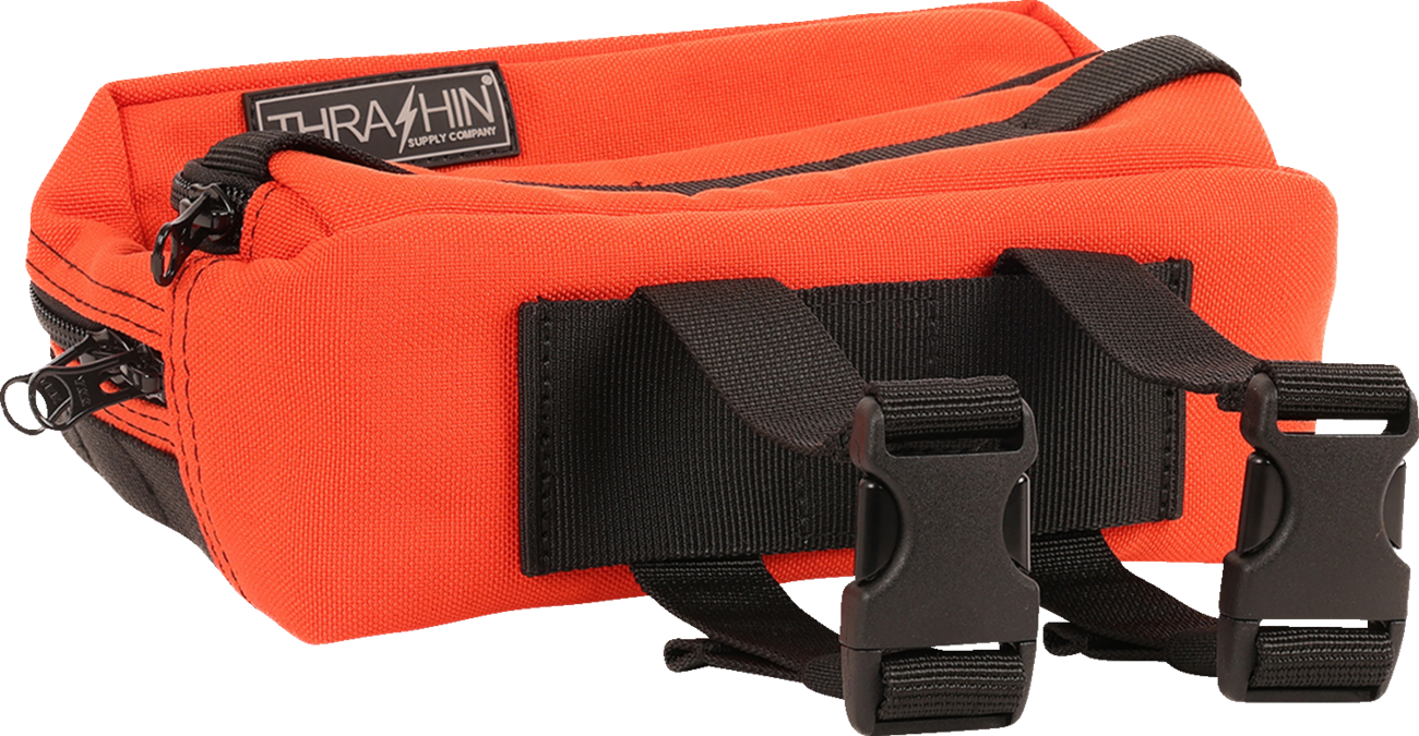 Orange THRASHIN SUPPLY CO. Handlebar Bag Plus mounted on a bike handlebar, featuring a durable, compact design for cycling essentials.