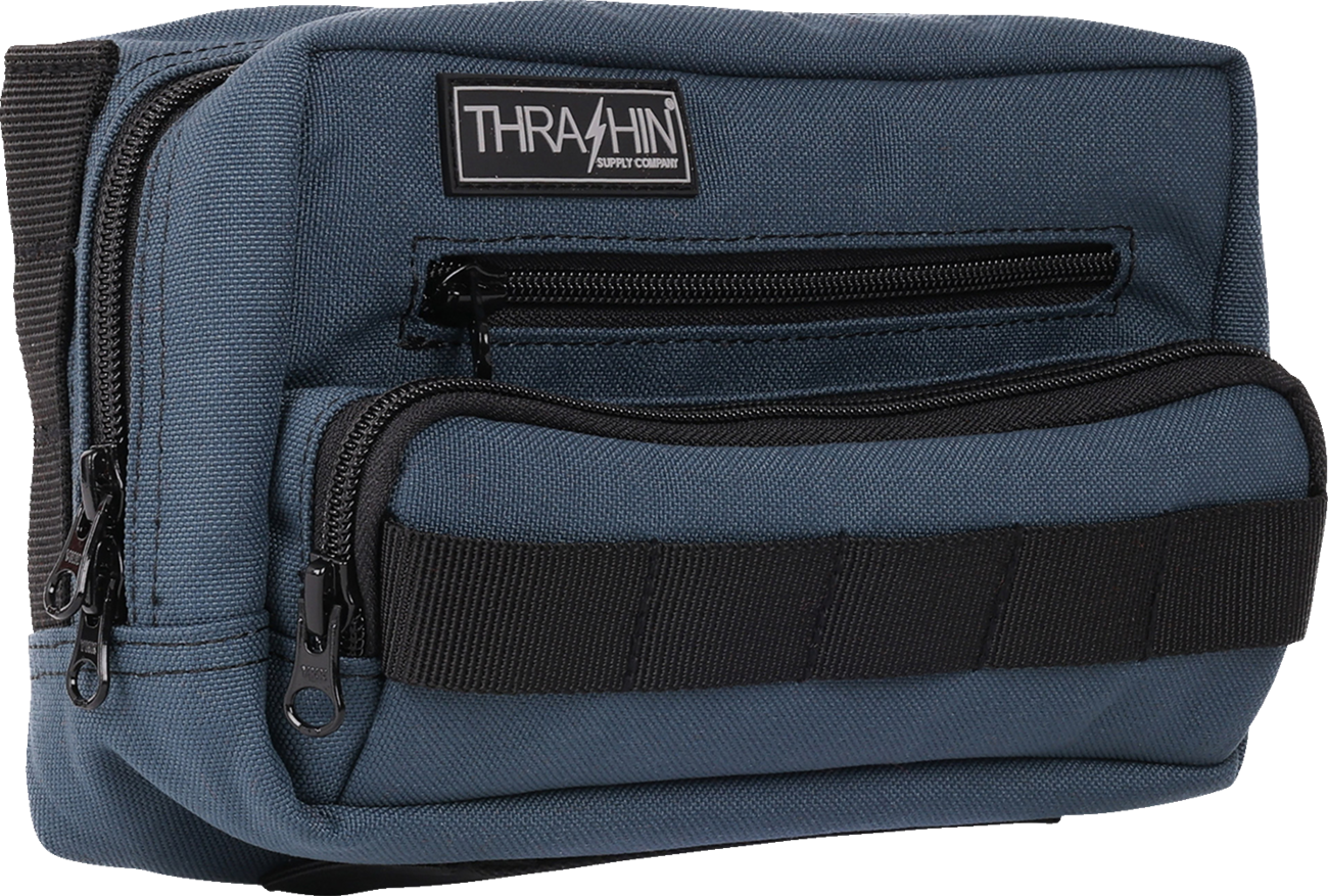 Blue THRASHIN SUPPLY CO. Handlebar Bag Plus mounted on a bicycle handlebar, showing its compact, durable design.