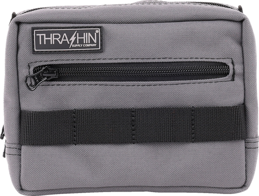 Gray handlebar bag by THRASHIN SUPPLY CO. with adjustable straps and compact design, mounted on bicycle handlebars.