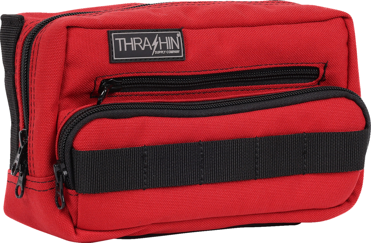 Red Thrasin Supply Co. Handlebar Bag Plus mounted on a bicycle handlebar, showcasing its compact design and secure strap system.