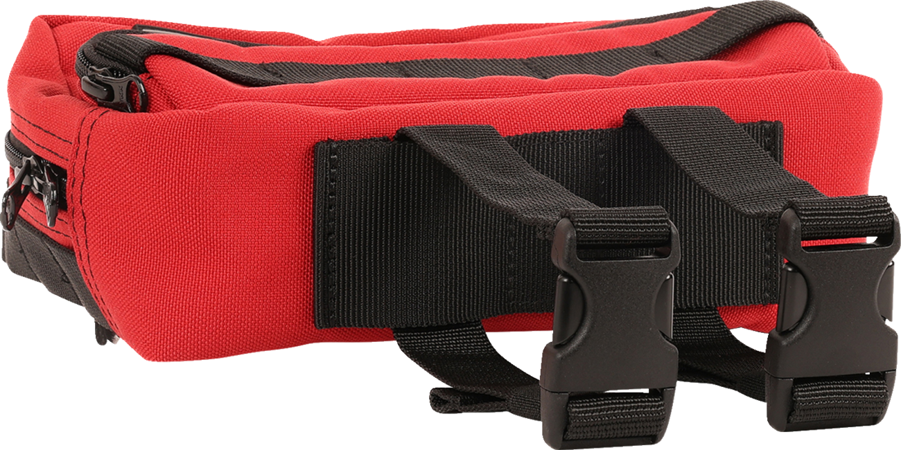 Red THRASHIN SUPPLY CO. Handlebar Bag Plus mounted on a bicycle handlebar, showing its compact design and secure strap system.