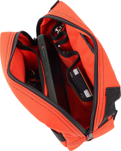 Orange handlebar bag from THRASHIN SUPPLY CO. with adjustable straps and compact design for cycling storage.