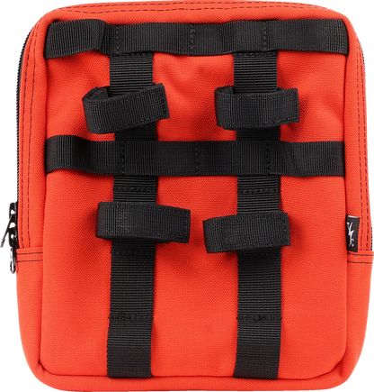 Orange THRASHIN SUPPLY CO. Handlebar Bag Slim (THB-0035) mounted on a bicycle handlebar, showing its compact design and secure strap system.