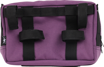 Purple THRASHIN SUPPLY CO. Handlebar Bag Plus mounted on a bicycle handlebar, with adjustable straps and compact design.