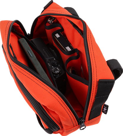 Orange THRASHIN SUPPLY CO. Handlebar Bag Plus mounted on a bicycle handlebar, featuring durable material and secure attachment.
