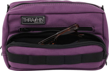 Purple THRASHIN SUPPLY CO. Handlebar Bag Plus mounted on a bicycle handlebar, showing its compact design and secure attachment.