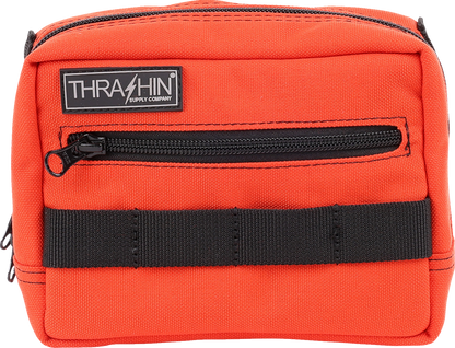 Orange handlebar bag by THRASHIN SUPPLY CO. with adjustable straps and compact design for bike storage.