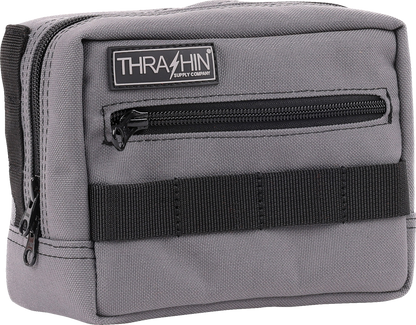 Gray THRASHIN SUPPLY CO. handlebar bag attached to a bicycle, showcasing durable design and compact storage solution.