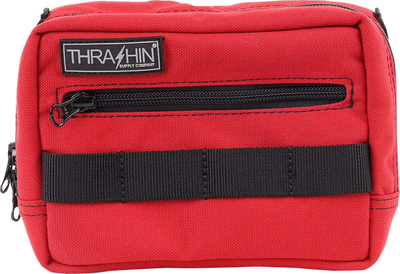 Red THRASHIN SUPPLY CO. handlebar bag with adjustable straps and compact design for bike storage.