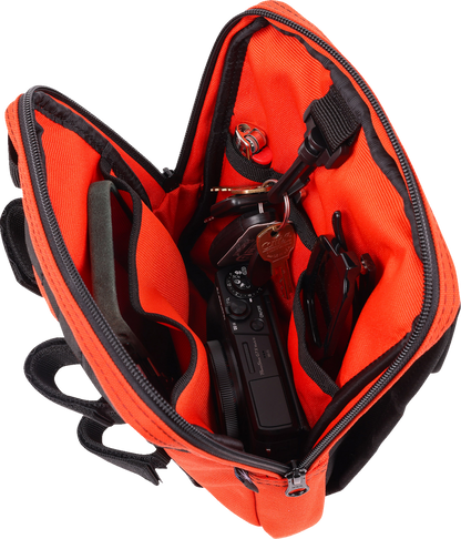 Orange THRASHIN SUPPLY CO. Handlebar Bag Slim with adjustable straps and compact design for cycling storage.