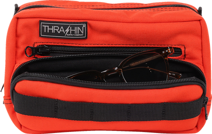 Orange handlebar bag by THRASHIN SUPPLY CO., featuring durable straps and compact design for bike storage.