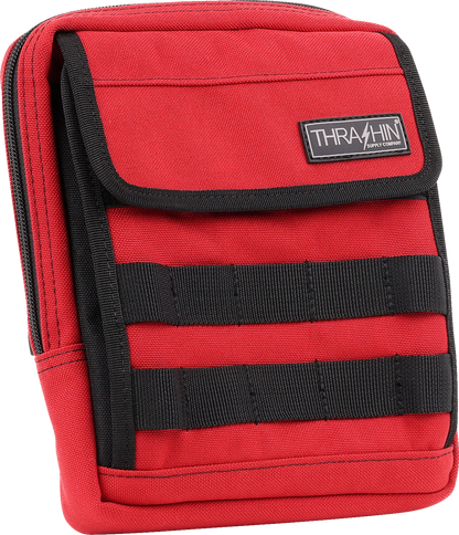 Red THRASHIN SUPPLY CO. Handlebar Bag Slim attached to a bicycle handlebar, showcasing its compact design and vibrant color.