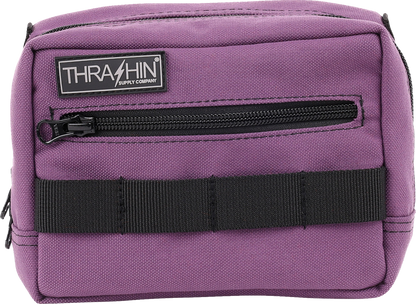 Purple handlebar bag from THRASHIN SUPPLY CO. with adjustable straps and compact design, mounted on a bicycle handlebar.
