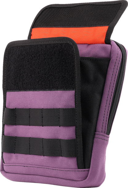 Purple THRASHIN SUPPLY CO. Handlebar Bag Slim attached to a bicycle handlebar, showcasing its compact design and secure strap system.