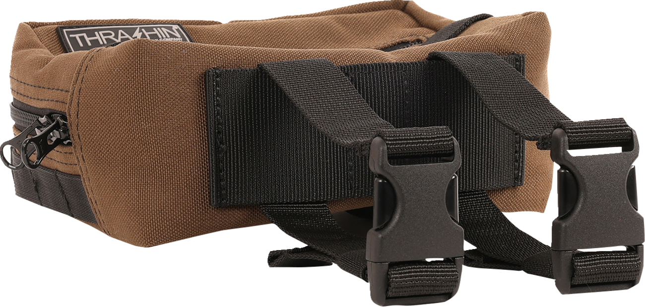 Brown THRASHIN SUPPLY CO. handlebar bag with MOLLE webbing and multiple attachment points for bikes and cycling gear.