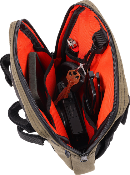 Green THRASHIN SUPPLY CO. Handlebar Bag Slim mounted on a bicycle handlebar, featuring compact design and adjustable straps.
