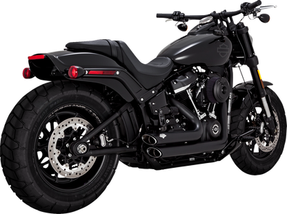VANCE & HINES Shortshots Staggered PCX™ exhaust system in matte black for motorcycle, showing the sleek, curved exhaust pipes.