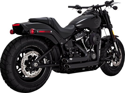 VANCE & HINES Shortshots Staggered PCX™ exhaust system in matte black for motorcycle, showing the sleek, curved exhaust pipes.
