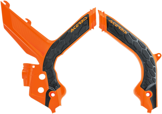 A set of Acerbis X-Grip frame guards in orange and black, designed for motorcycle protection, displayed on a neutral background.