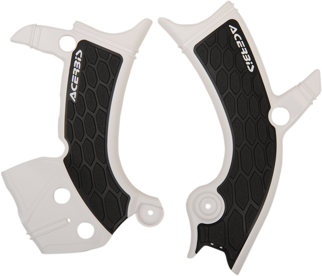 Acerbis X-Grip white and black motorcycle frame guards installed on a bike's body, providing protection and style.