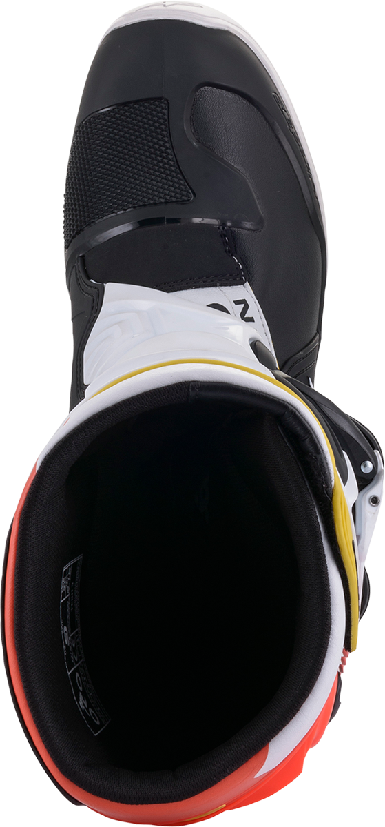 Alpinestars Tech 3 motorcycle boots in black, white, and orange with sturdy ankle protection and secure fastening.