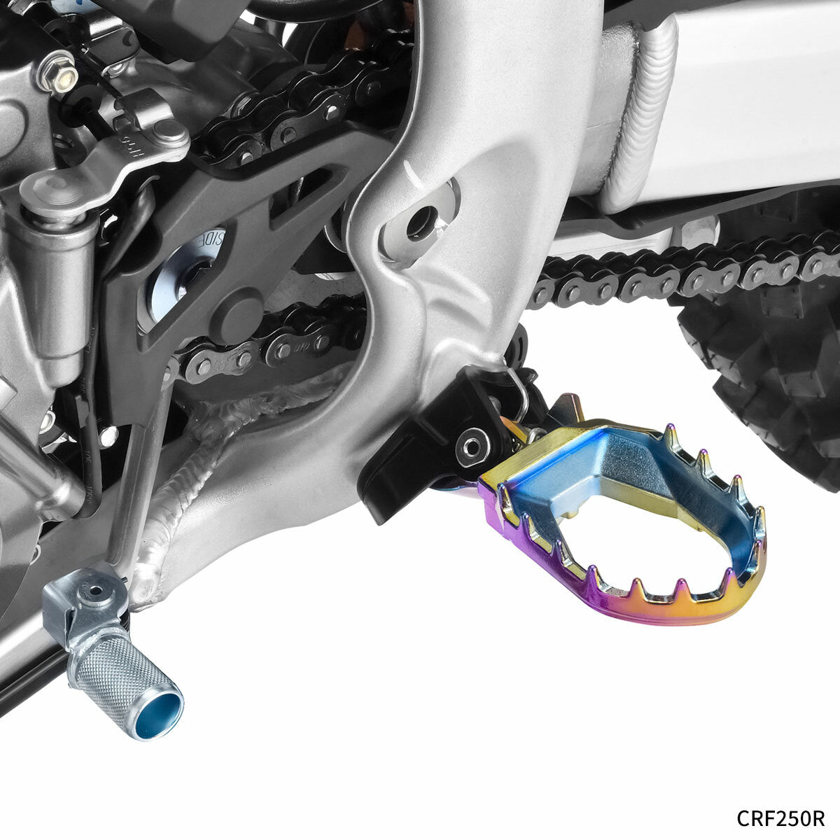 ZETA Max Foot Peg Hon Oilslick finish for motorcycle, shown with detailed textured surface and mounting points.
