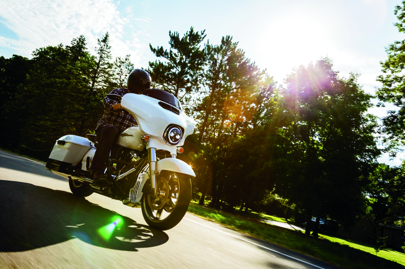 Kuryakyn chrome oil cooler cover for Harley Davidson Touring models, showcasing a sleek metallic finish and detailed design.