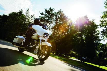 Kuryakyn chrome oil cooler cover for Harley Davidson Touring models, showcasing a sleek metallic finish and detailed design.