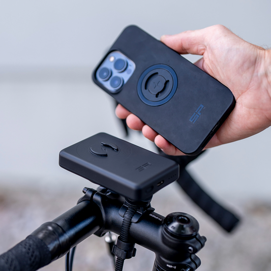 Bill's Exhausts SP CONNECT Wireless Power Bank SPC+ 52814 charging a smartphone, compact portable power bank with wireless charging capability.