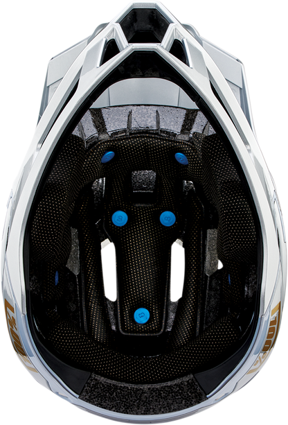 Silver 100% Trajecta bicycle helmet with Fidlock closure in large size, shown from the front with adjustable straps.