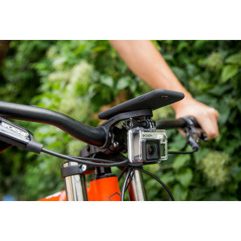 Black SP CONNECT handlebar phone mount by Bill's Exhausts attached to a motorcycle handlebar.