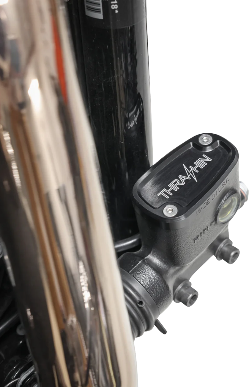Black rear brake reservoir cap for '18+ Softail, designed by THRASHIN SUPPLY CO., with twice cut detail for enhanced style.