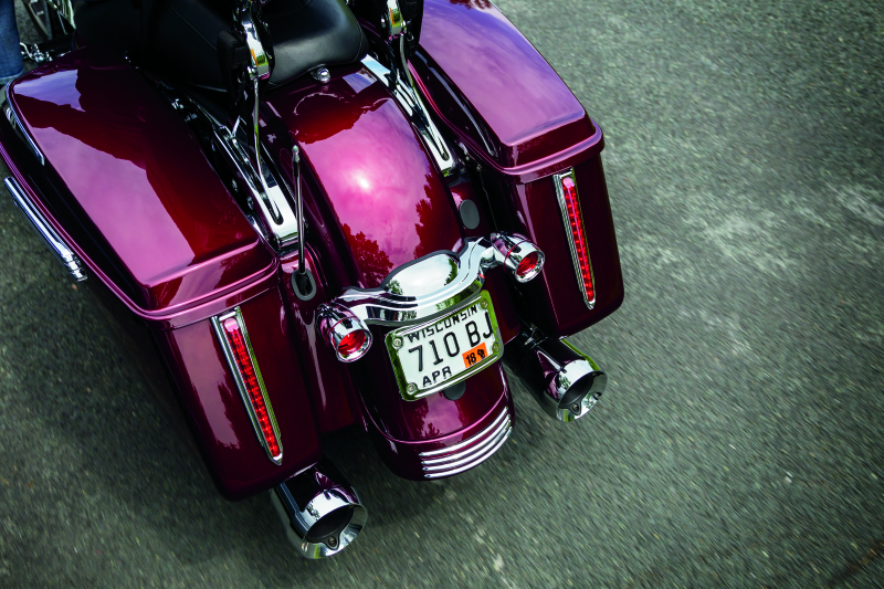 Chrome Kuryakyn curved license plate mount for Harley-Davidson Street Glide and Road Glide motorcycles.