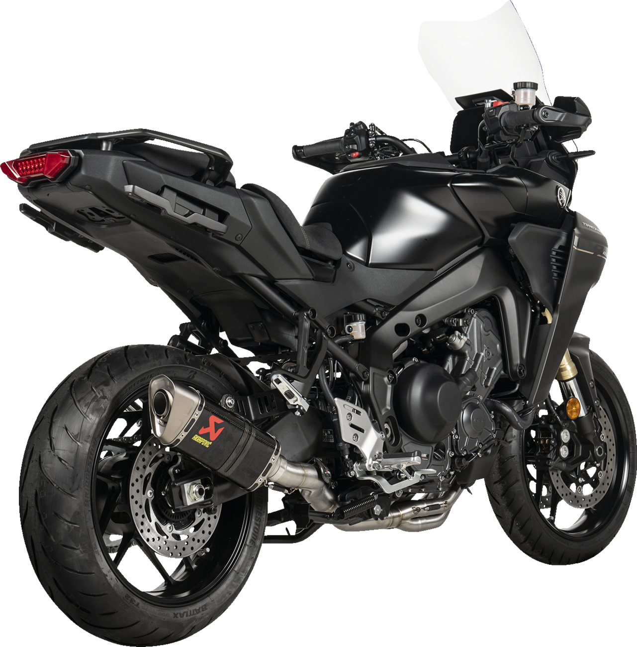 AKRAPOVIC Racing Line exhaust system with carbon fiber finish for Yamaha Tracer 9 motorcycle, showcasing sleek metal and carbon details.