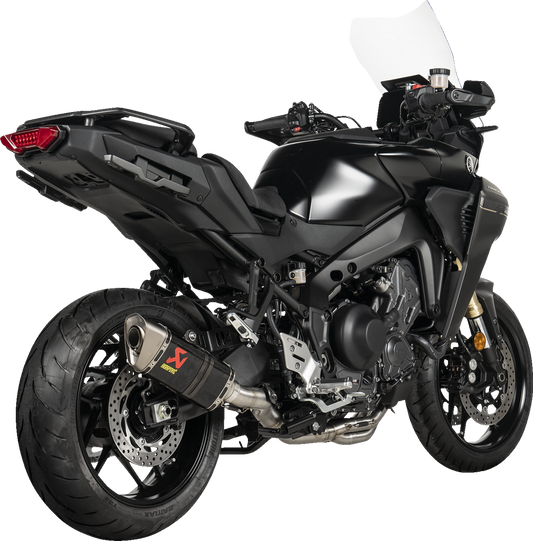 AKRAPOVIC Racing Line exhaust system with carbon fiber finish for Yamaha Tracer 9 motorcycle, showcasing sleek metal and carbon details.
