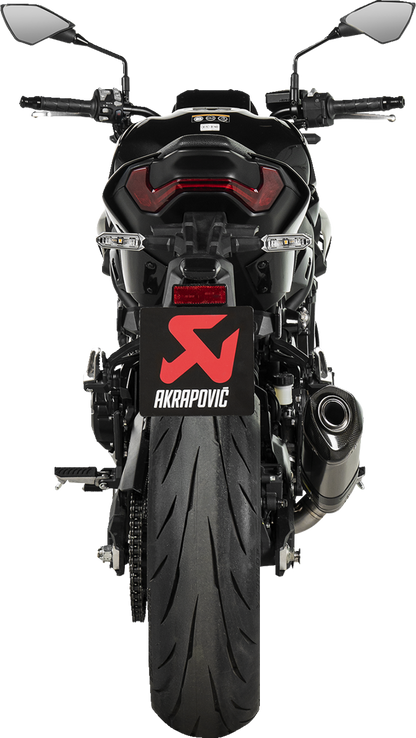 AKRAPOVIC slip-on muffler for Kawasaki Z900 motorcycle in titanium finish, showcasing sleek design and polished surface.