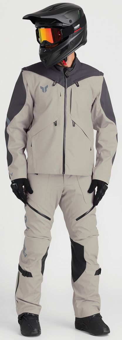 THOR Terrain over-the-boot pants in sand color, US 38 size, showing durable fabric and adjustable waistband.