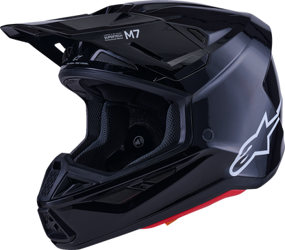 Alpinestars SM7 helmet in solid gloss black, large size, featuring sleek aerodynamic design and ventilation vents.