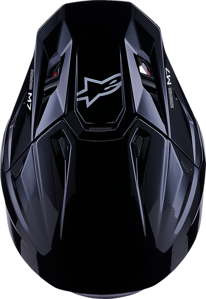 Alpinestars SM7 helmet in solid gloss black, large size, with aerodynamic design and ventilation vents visible.