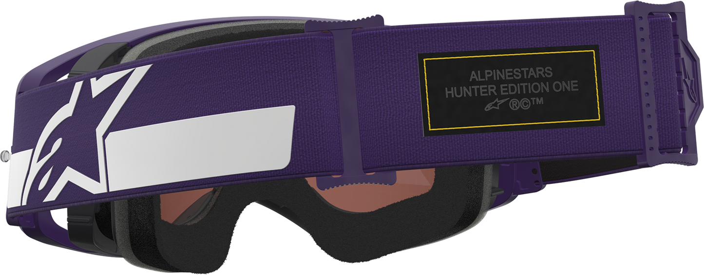Alpinestars Gogglessupertech Hunta 96 XXV goggles in purple and white with silver mirror lens, showcasing sporty design and adjustable strap.