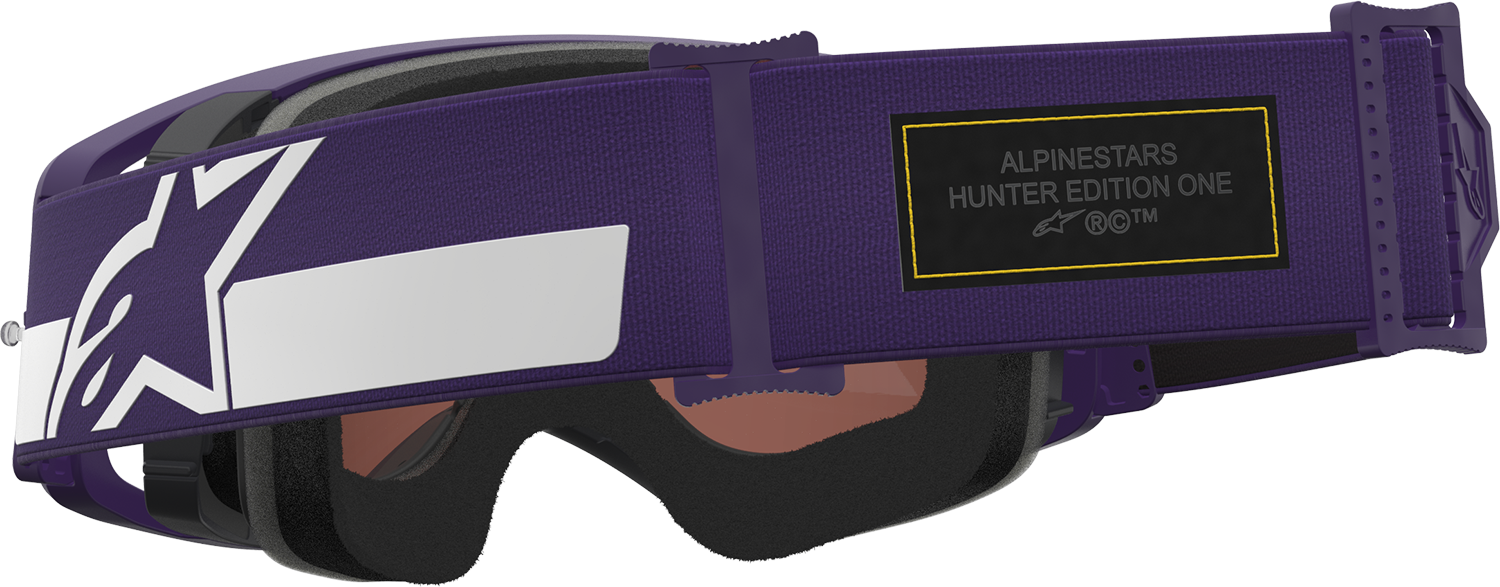 Alpinestars Gogglessupertech Hunta 96 XXV goggles in purple and white with silver mirror lens, showcasing sporty design and adjustable strap.